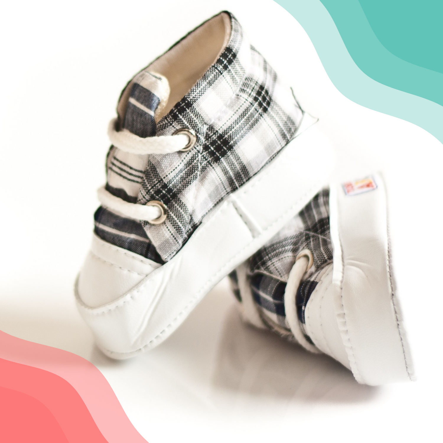 A pair of black and white plaid infant shoes