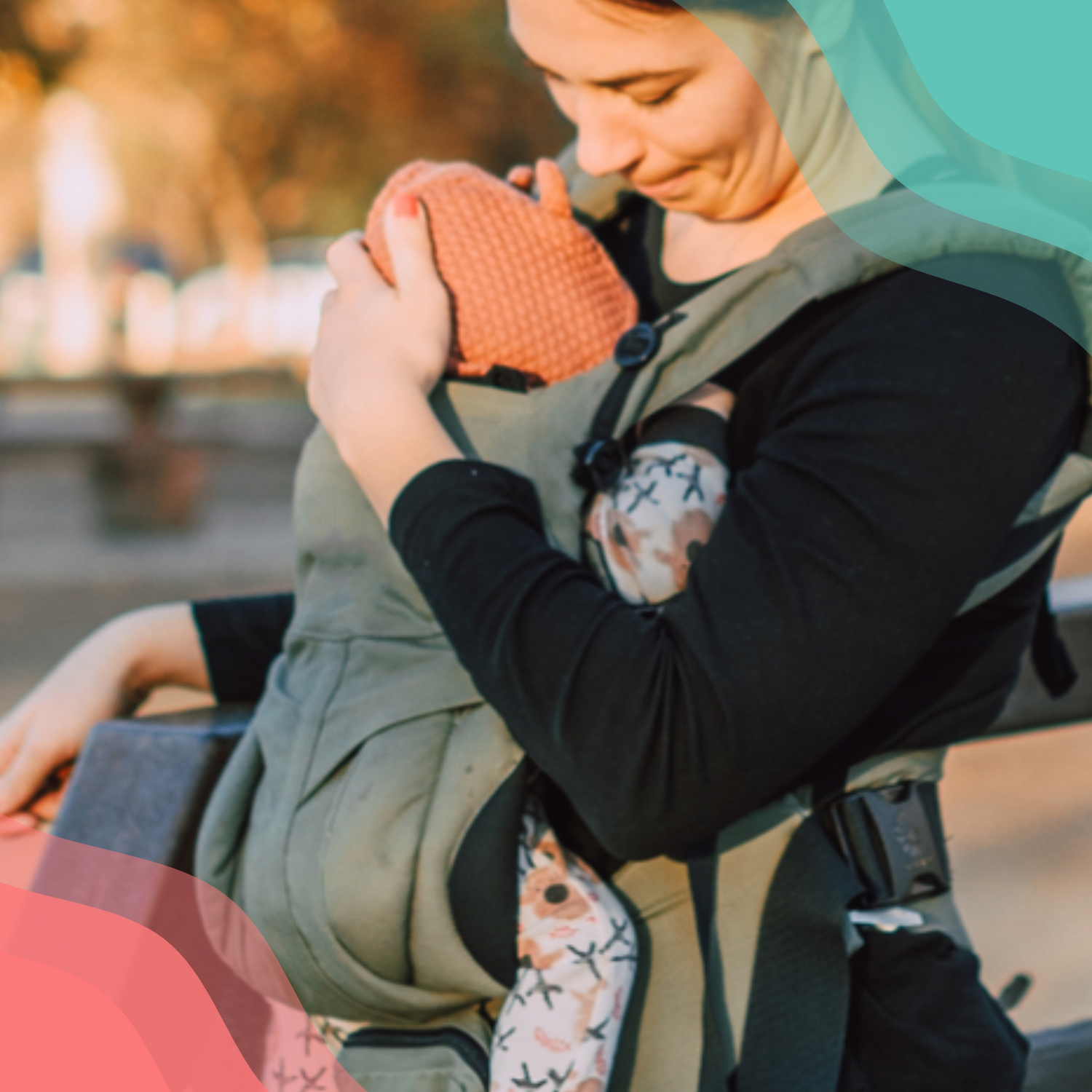 A woman holding a small child in her baby sling.